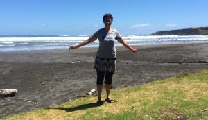 Woman standing at Opunake Beach New Zealand